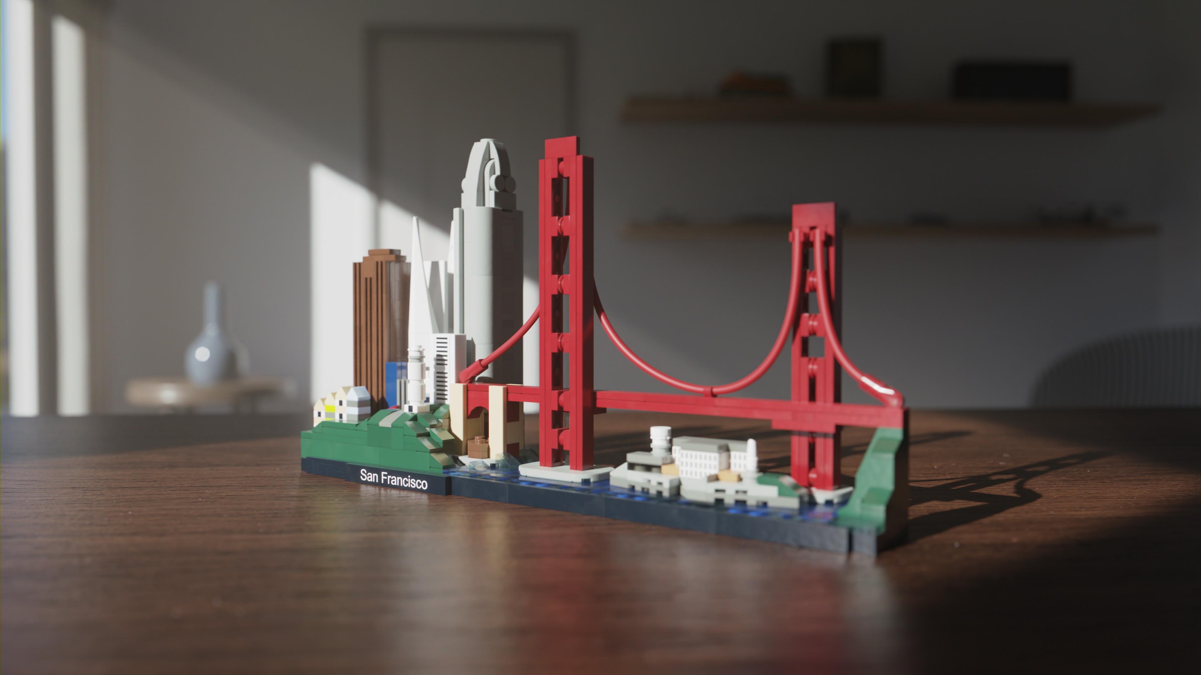 Image of a Lego Model of San Francisco, sitting on table in a room lit with some windows on the left-hand side.