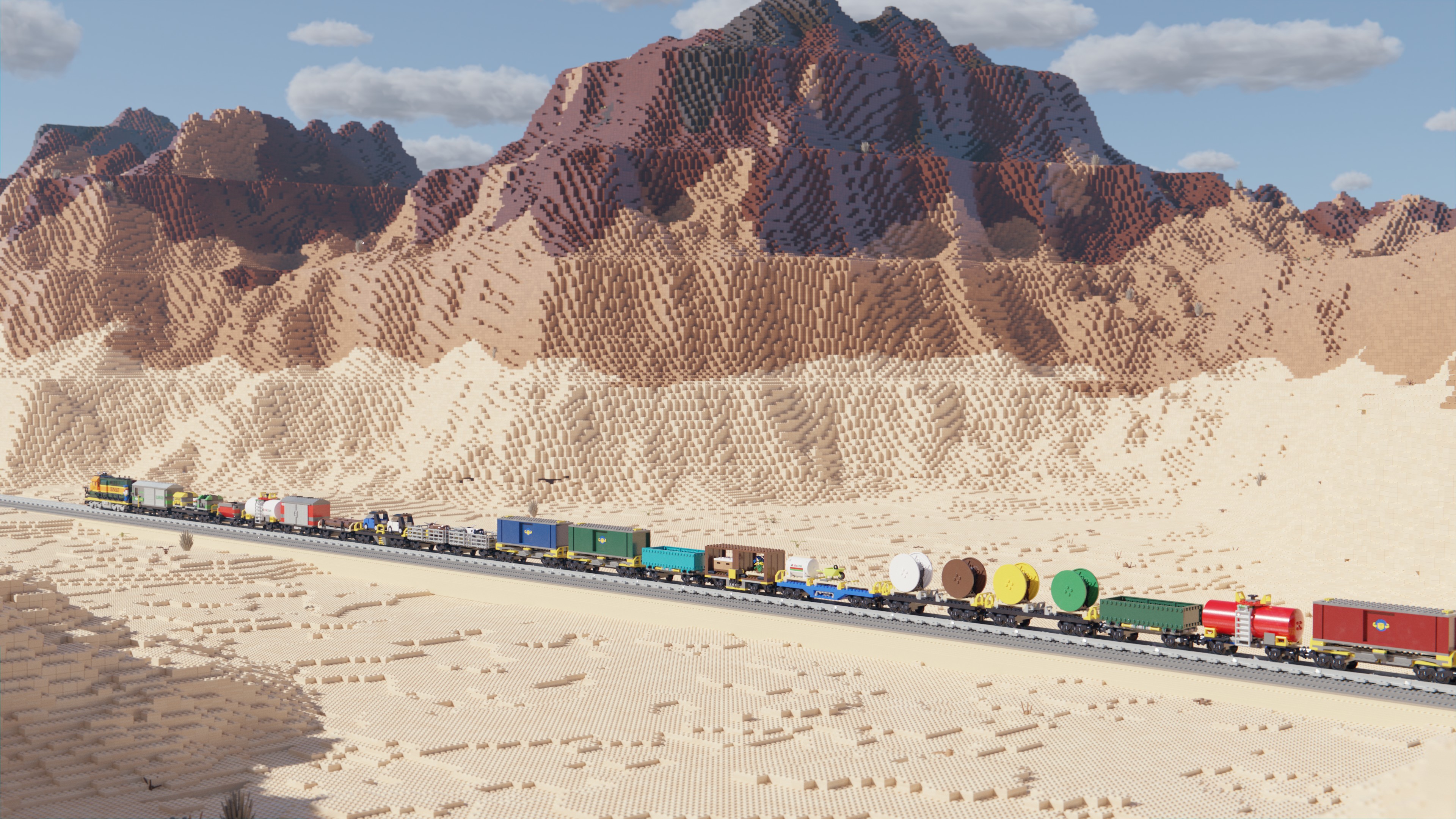 Image of a Lego train travelling through a desert landscape on a sunny day with some clouds in the sky.